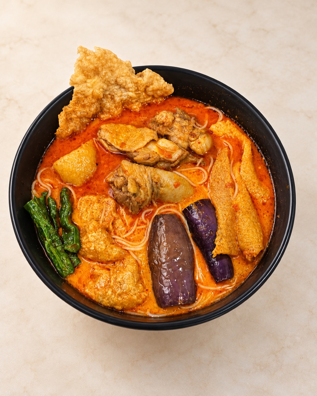 Chicken curry noodles with aubergine, long beans and tofu puffs
